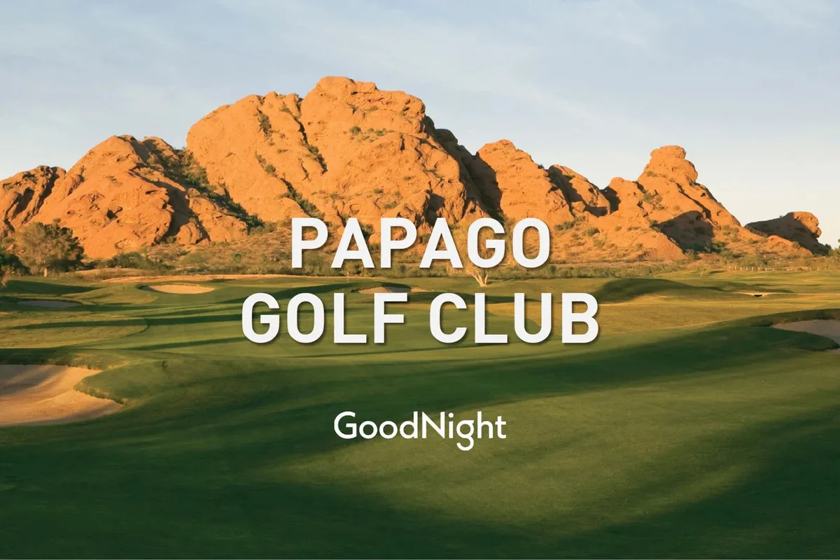 A serene exterior shot of a golf course at sunset, with rock formations and a beautiful sky in the background. The scene hints at leisurely activity, social interaction, and opportunities for relaxation after a round of golf.